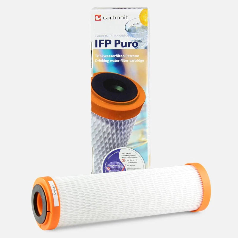 Carbonit Puro Wasserfilter mit orangefarbenen Ringen liegt vor der Produktverpackung.